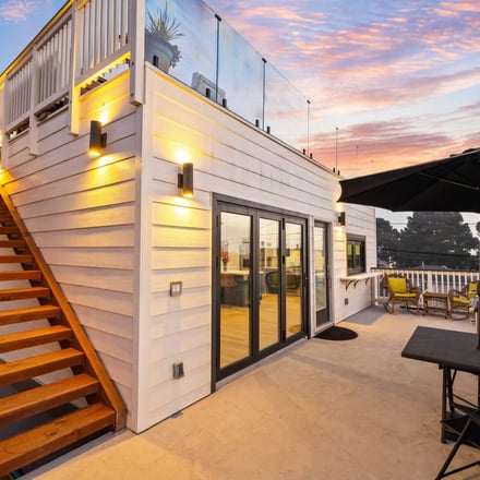 Rooftop deck with warm staircase lighting at dusk