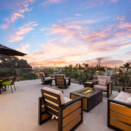 Rooftop fire pit lounge with San Diego city views at sunset