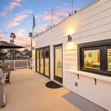 Rooftop BBQ deck with American flag at sunset