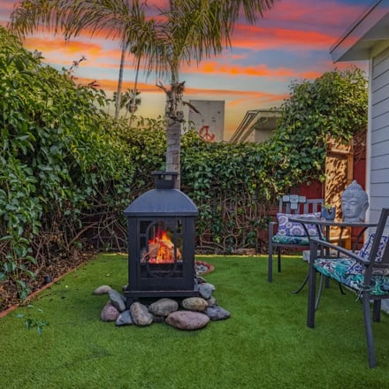 Backyard garden fire stove with palm tree at sunset
