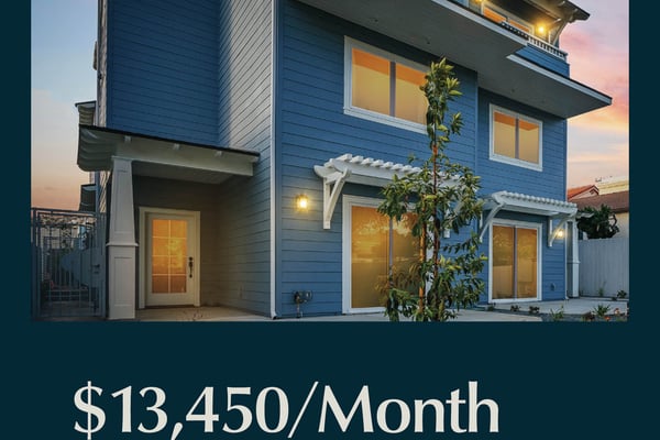 Modern blue two-story house with lit windows and balconies at dusk, climbing vine, white pergolas